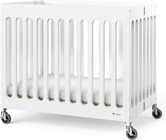 Foundations Boutique Folding Mini Baby Crib - Compact, Portable, Wooden Hotel Crib, Foldable Mini Crib for Baby & Toddlers - Includes 3" Foam Mattress, White