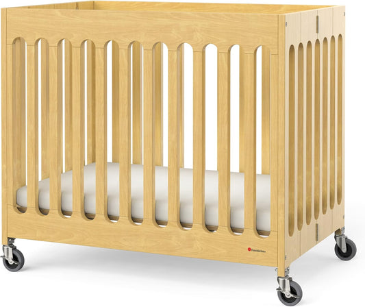 Foundations Boutique Folding Mini Baby Crib - Compact, Portable, Wooden Hotel Crib, Foldable Mini Crib for Baby & Toddlers - Includes 3" Foam Mattress, Natural